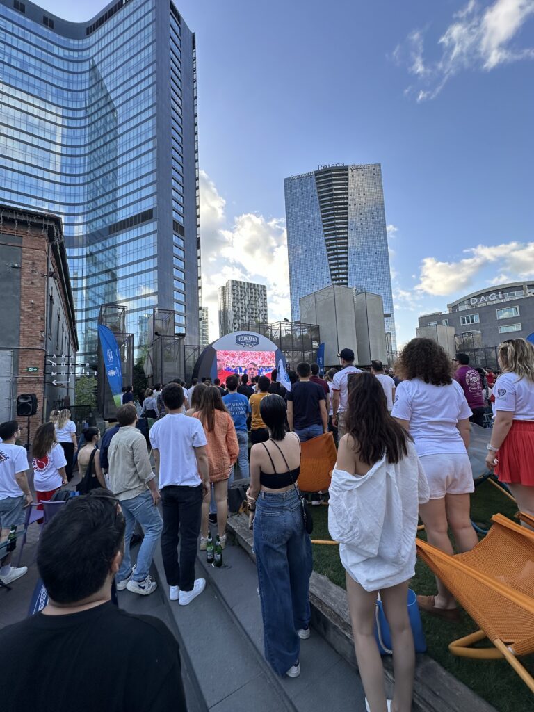 Crowd watching a football match screening in Bomontiada courtyard